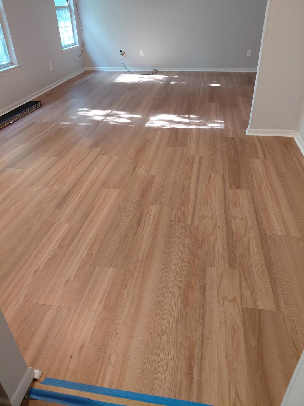 Plank floor finished in an empty room with afternoon light across it