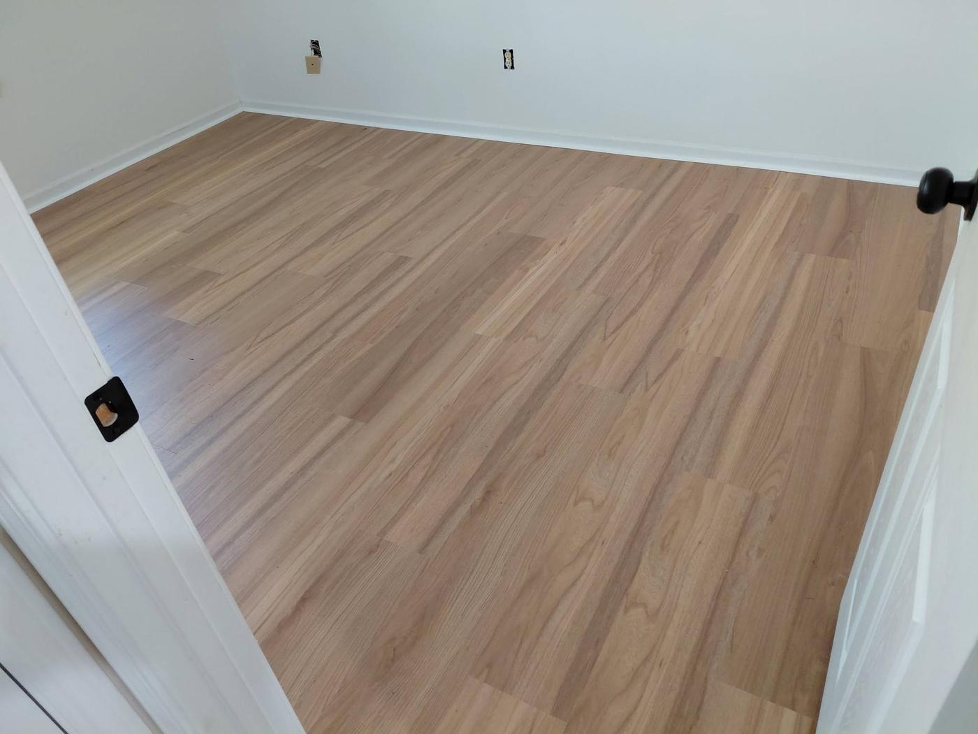 Plank floor laid wall to wall in a bedroom